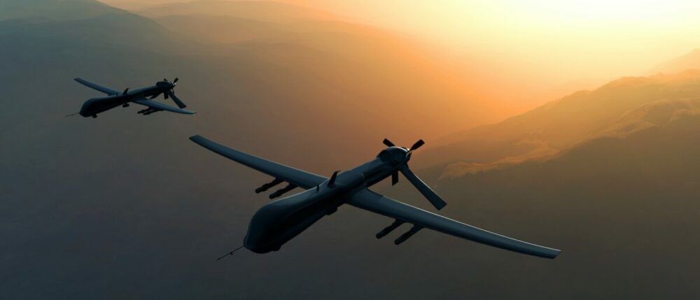 Two drones flying in the sky during sunset, showcasing a dramatic backdrop of mountains and atmospheric colors.