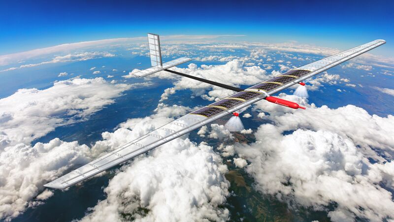 A large solar-powered aircraft gliding above fluffy white clouds with a clear blue sky in the background.