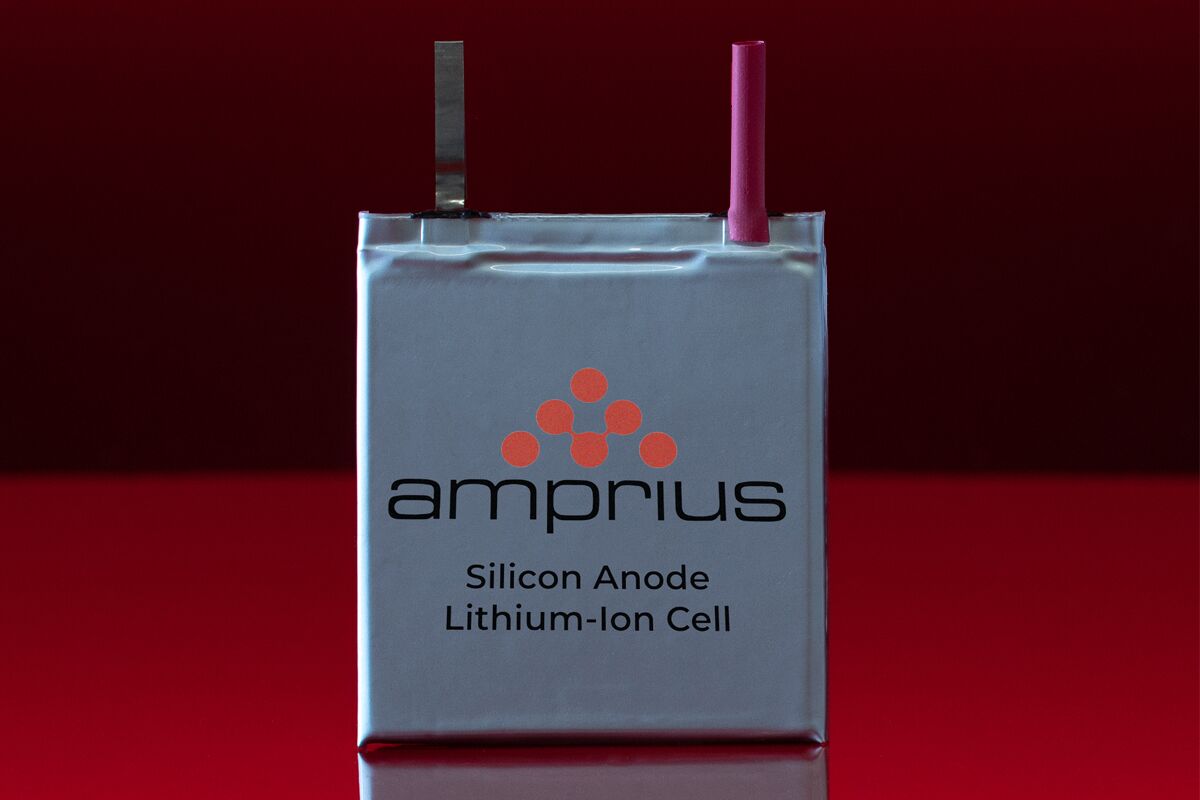 A lithium-ion cell from Amprius, featuring a silicon anode, with distinct terminal connectors and set against a red background.