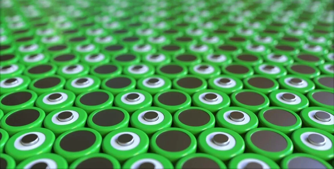 A grid of cylindrical green lithium-ion batteries demonstrating the need for battery recycling strategy and programs.
