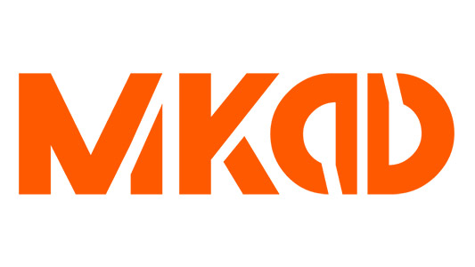 A bold orange logo consisting of stylized letters "MKAD" with varying shapes and alignments.